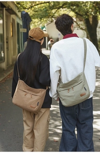 Outdoor shot of minimalist large capacity nylon crossbody bags in khaki and green