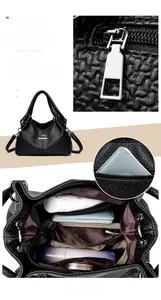 Detail view of large capacity black pebbled leather handbag with multiple compartments