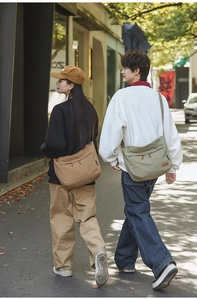 Detail of canvas crossbody bags in brown and olive green with adjustable straps