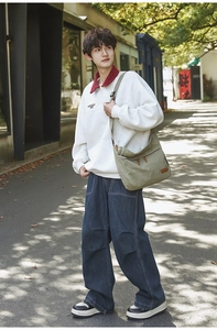 Urban retro streetwear set with zip sweatshirt and wide leg denim jeans with green bag