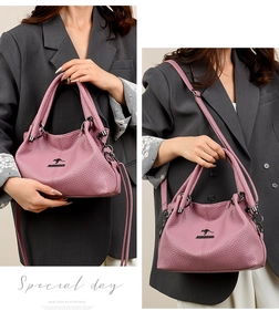 Detail of lavender textured leather tote with kangaroo logo and metallic hardware