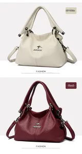Detailed view of the embossed leather texture and kangaroo metal logo on the handbag