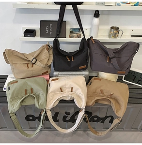 Detail of minimalist hobo bags in six colors with adjustable wide shoulder straps