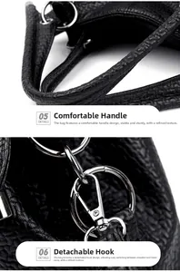 Detail of soft leather handle and silver detachable metal hook on black tote bag