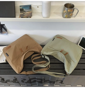 Close-up of khaki and green messenger bags with durable canvas and adjustable straps