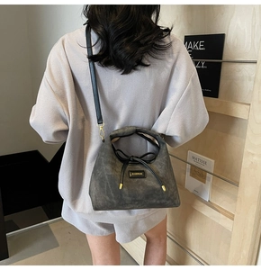 Detail of dark gray matte tote bag with BAMIROO logo and elegant black bow drawstring