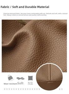 Macro view of dark brown litchi grain leather texture and high-quality stitching detail