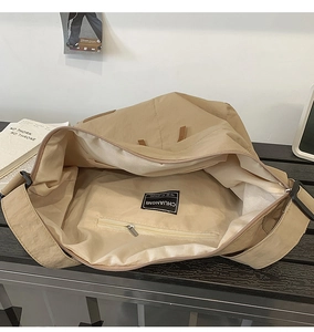 Top view of khaki nylon tote bag showing spacious interior and zippered inner pocket