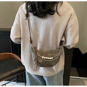 Detail of crescent shoulder bag with vintage silver chain and pearl ornaments