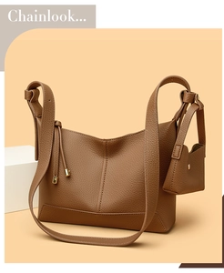 Macro detail of brown litchi pattern leather bag with matching mini pouch charm
