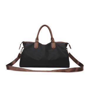 Large black nylon travel duffel bag with brown leather handles and adjustable shoulder strap