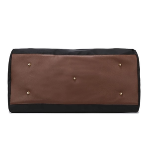 Bottom view of large travel bag with wear-resistant metal studs and leather base