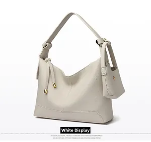 Detailed macro view of white pebble leather texture and elegant knot shoulder strap