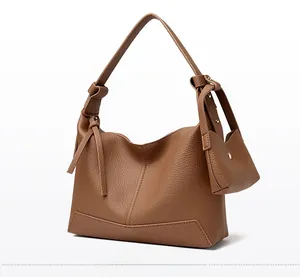Brown lychee texture hobo bag with knotted side details and a matching mini coin purse