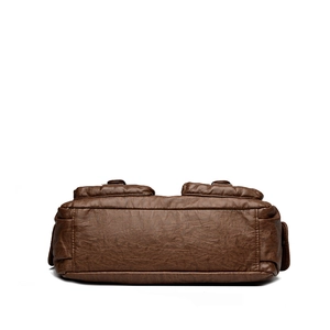 Bottom view of large vintage brown leather shoulder bag with pebbled texture details