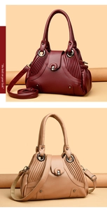 Detail of lychee pattern leather handbags with side pleats and silver hardware