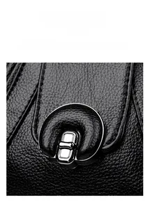 Macro view of textured black lychee leather with chic silver metal hardware lock detail