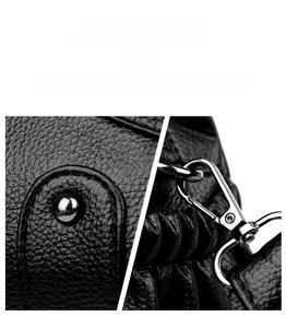 Detail of silver hardware latch and black lychee grain leather texture on bag
