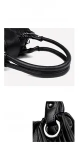 Detail of reinforced black litchi grain leather handle and polished silver ring buckle
