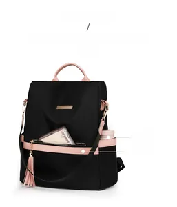 Detail view of pink leather handle and tassels on waterproof nylon commuter backpack