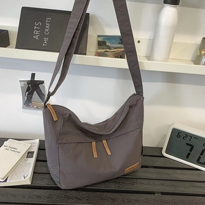 Minimalist large charcoal grey nylon crossbody bag for women in home setting