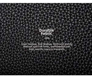 Close-up of wear-resistant black litchi pattern leather with fine texture on handbag