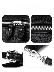 Close-up of black lychee grain leather texture and polished silver metal hardware details