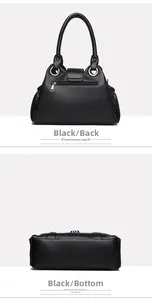 Detail view of black lychee leather bag showing silver zipper pocket and flat bottom base