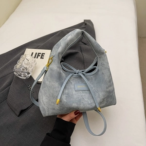 Minimalist light blue stone-wash hobo bag with ribbon detail and crossbody strap
