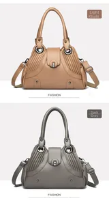 Detail view of khaki and grey shoulder bags featuring pleated design and metal buckle