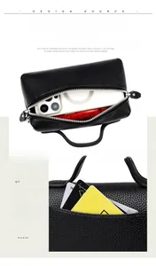 Detail of black pebbled leather clutch showing spacious interior and card slot storage