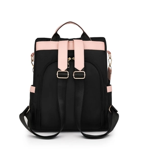 Detail of backpack back with adjustable straps, pink leather trim, and gold hardware