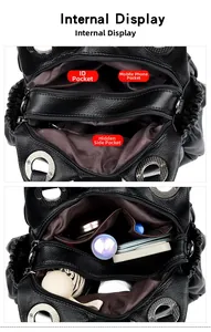Internal view of black leather shoulder bag showing multi-pocket compartments and lining