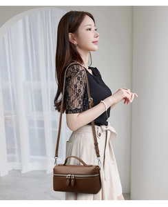 Brown litchi grain leather box bag with adjustable shoulder strap and top handle