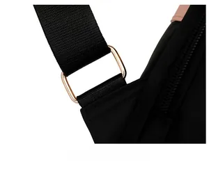 Detail of reinforced shoulder strap stitching with elegant rose gold metal buckle hardware
