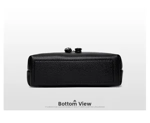 Detail view of the rectangular bottom base of a black lychee texture leather shoulder bag