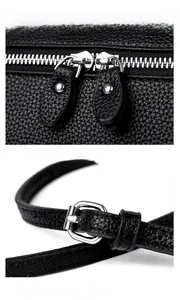 Detail of dual metal zippers and adjustable silver buckle on black lychee leather bag