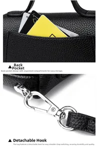 Detail view of black lychee leather bag featuring a back slot pocket and silver hooks