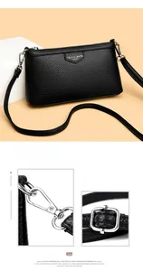 Détail du sac à main en cuir noir texturé litchi avec fermoirs métalliques argentés polis