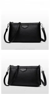 Détail du sac bandoulière noir avec texture grainée litchi et fermeture éclair en métal