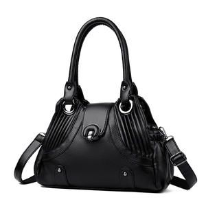 Fashionable black pebbled leather underarm bag with silver rivets and top handle