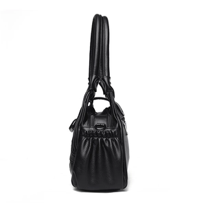 Side view of black trendy underarm bag with lychee texture leather and rivet details