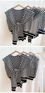 Detail of black and white houndstooth knitted shawl with various geometric textures
