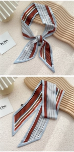 Détail d'un foulard en soie aux motifs géométriques bleu et marron et texture lisse
