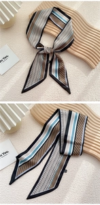 Détail d'un foulard en soie twilly à motifs géométriques noué en nœud élégant