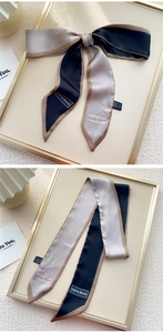 Détail d'un nœud en satin tricolore avec marquage élégant de la marque Doria Dore