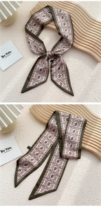 Détail d'un foulard en soie avec bordures vert olive et imprimé éléphant rétro sur bois