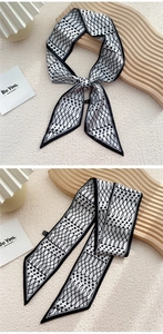 Détail d'un foulard twilly en soie noir et blanc à motifs géométriques et pois élégants