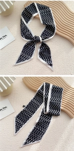 Détail d'un foulard long en soie avec motif géométrique abstrait noir et blanc à pois