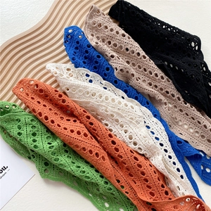 Handmade hollow crochet shawl in six vibrant colors displayed on a wooden tray